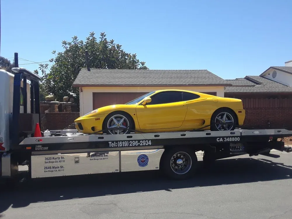 Yellow sports car strapped down on an Advantage Towing rollback