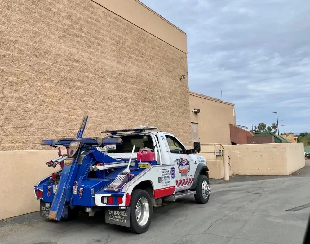 Advantage Towing wrecker from the rear quarter with its blue boom raised
